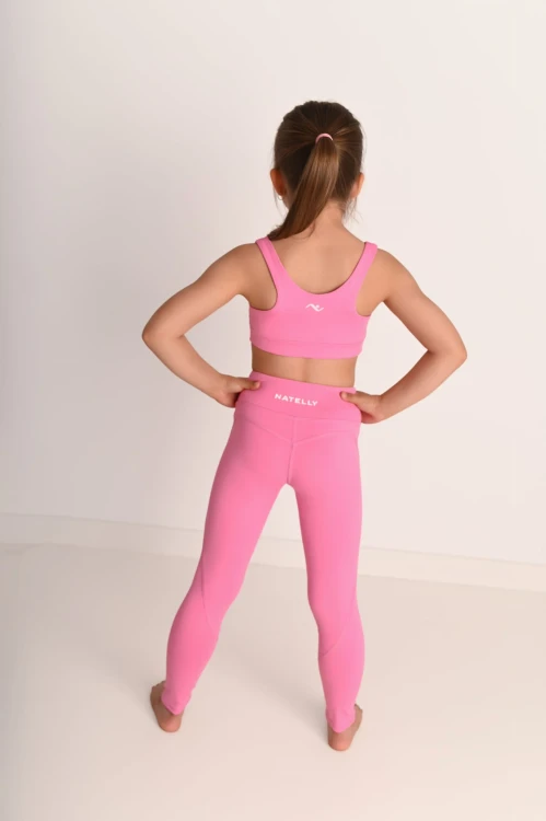 Legginsy dziewczęce z przeszyciami ActiveGlow różowe - modelka stoi tyłem