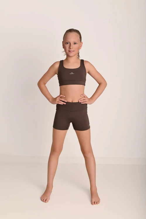 Top dziewczęcy ActiveGlow brązowy - modelka stoi tyłem