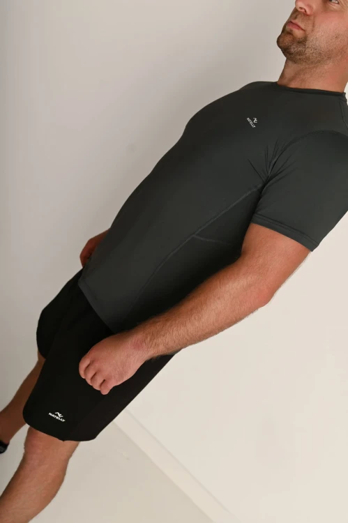 Męska szara koszulka z przeszyciami i odblaskiem Action - model stoi bokiem